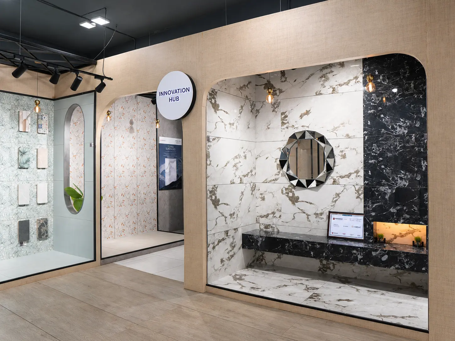 Innovation Hub tile display with marble-look slabs, patterned tiles and mirror detailing.
