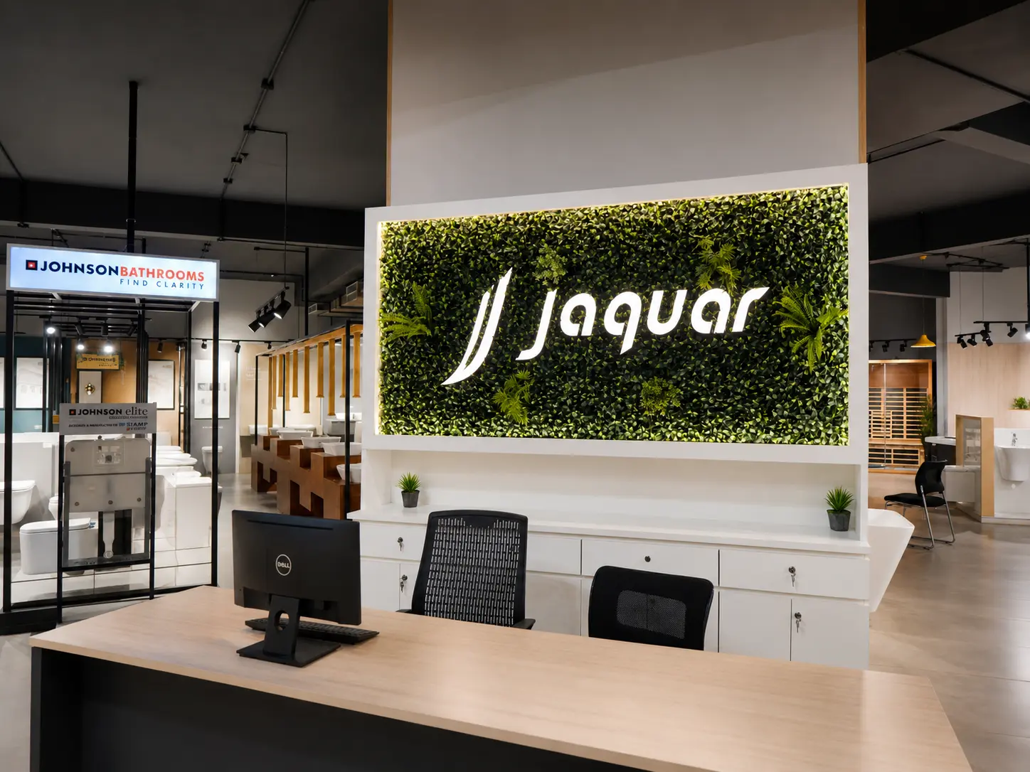 i-KEYZ showroom reception desk with Jaquar signage and bathroom displays behind it.