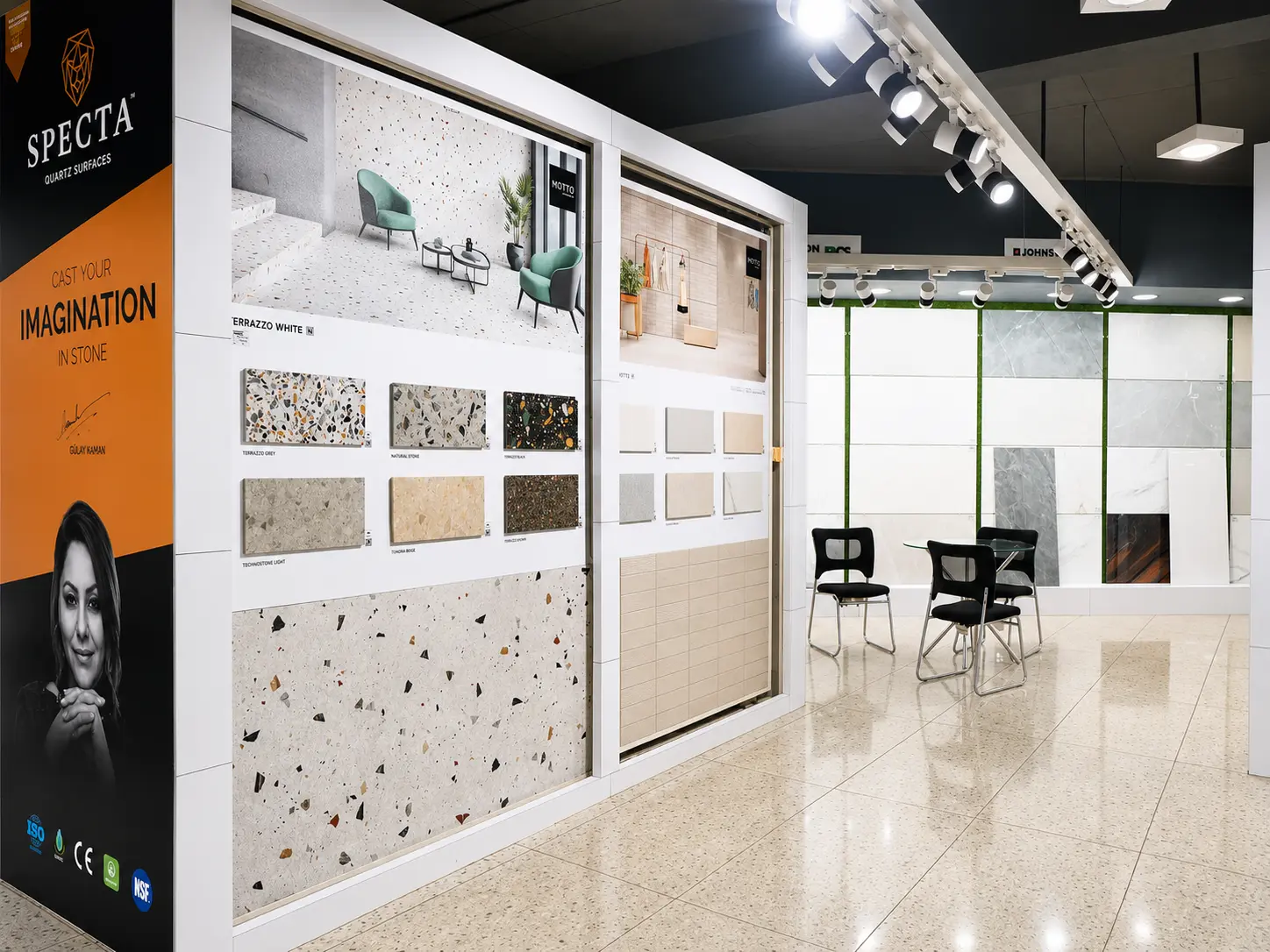 Stone and quartz surface sample displays with seating area and product panels.