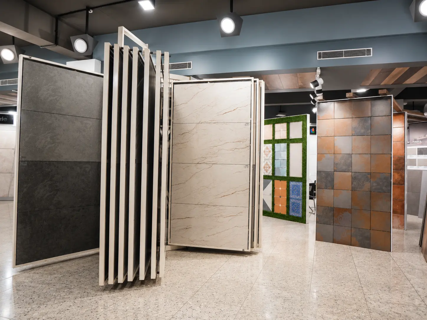Large tile sample panels and feature wall displays inside the i-KEYZ showroom.